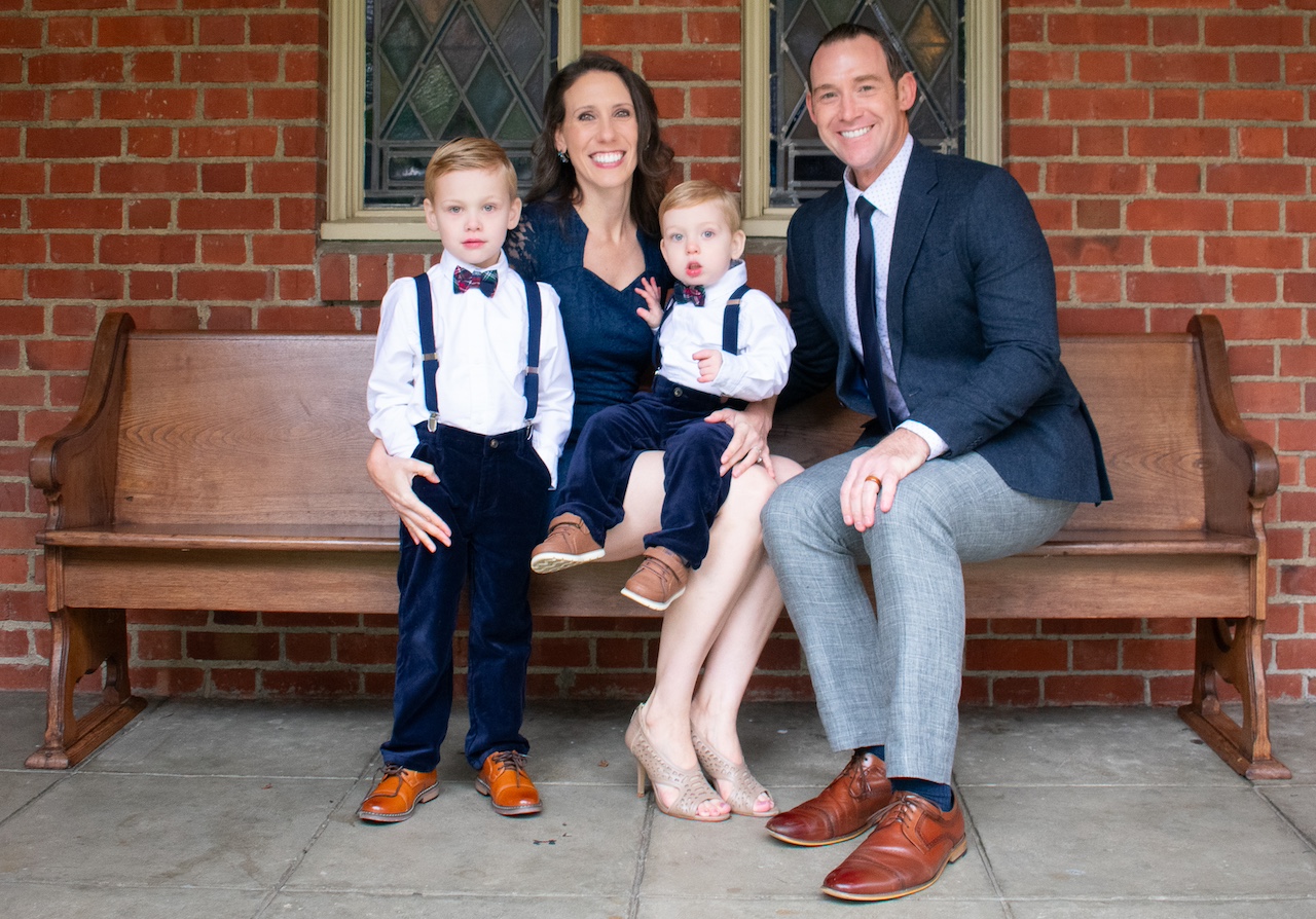 Nicole Devencenzi poses with her husband Peter, and two young sons.